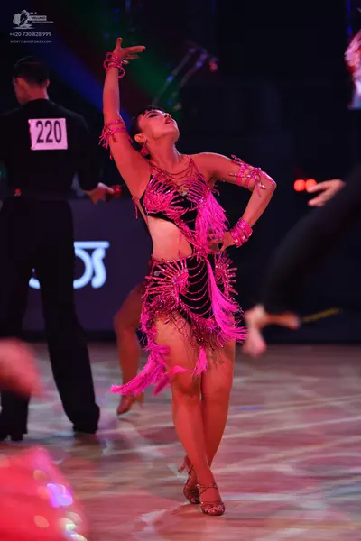Dancesport competitor: Male dancer: black long-sleeved top and black trousers