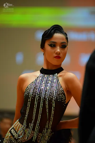 Dancesport competitor: Female dancer: black halter-neck latin dress with vertical stripes of silver and