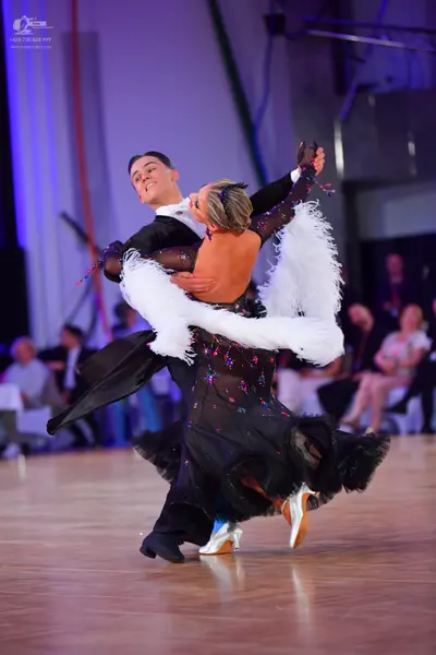 Dancesport competitor: Male dancer: black long-sleeved dance shirt and black trousers