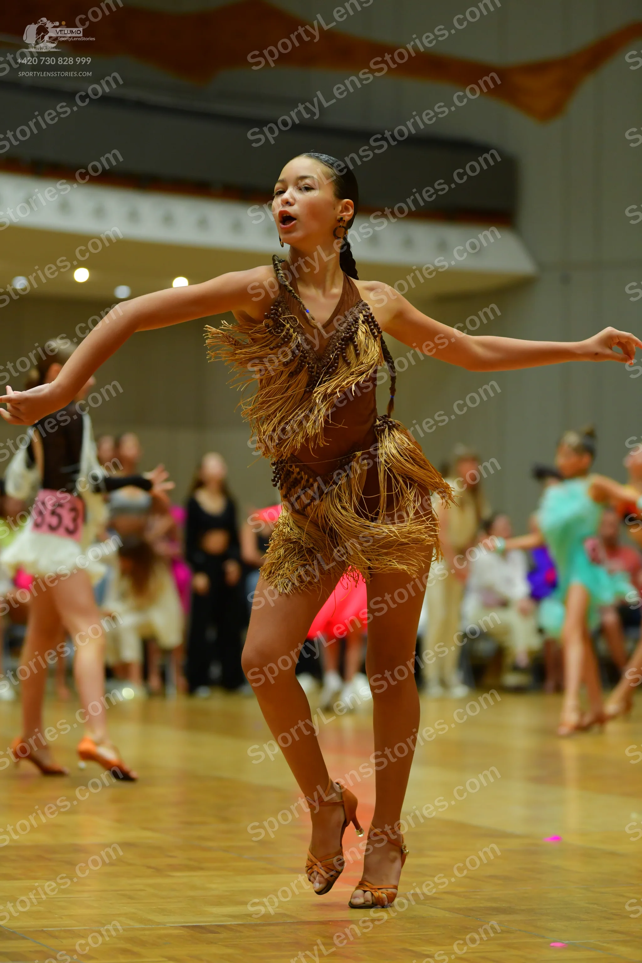Dancesport competitor: ** Female: Tan/Gold Latin dress