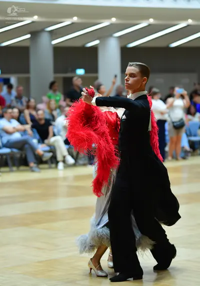 Dancesport competitor: Male dancer: black suit with a white shirt