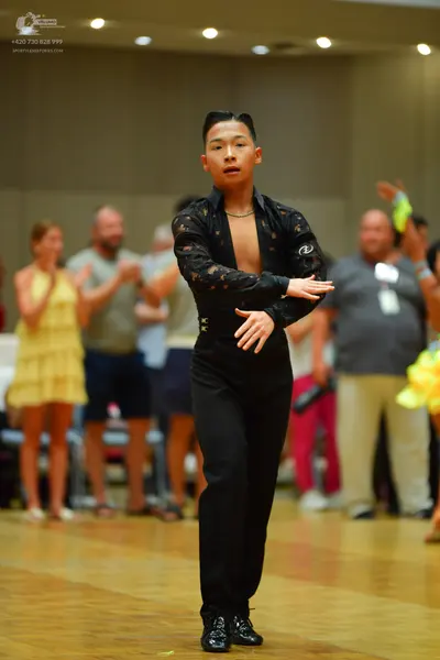Dancesport competitor: Male dancer: black long-sleeved shirt with a lace pattern, open at the chest, an
