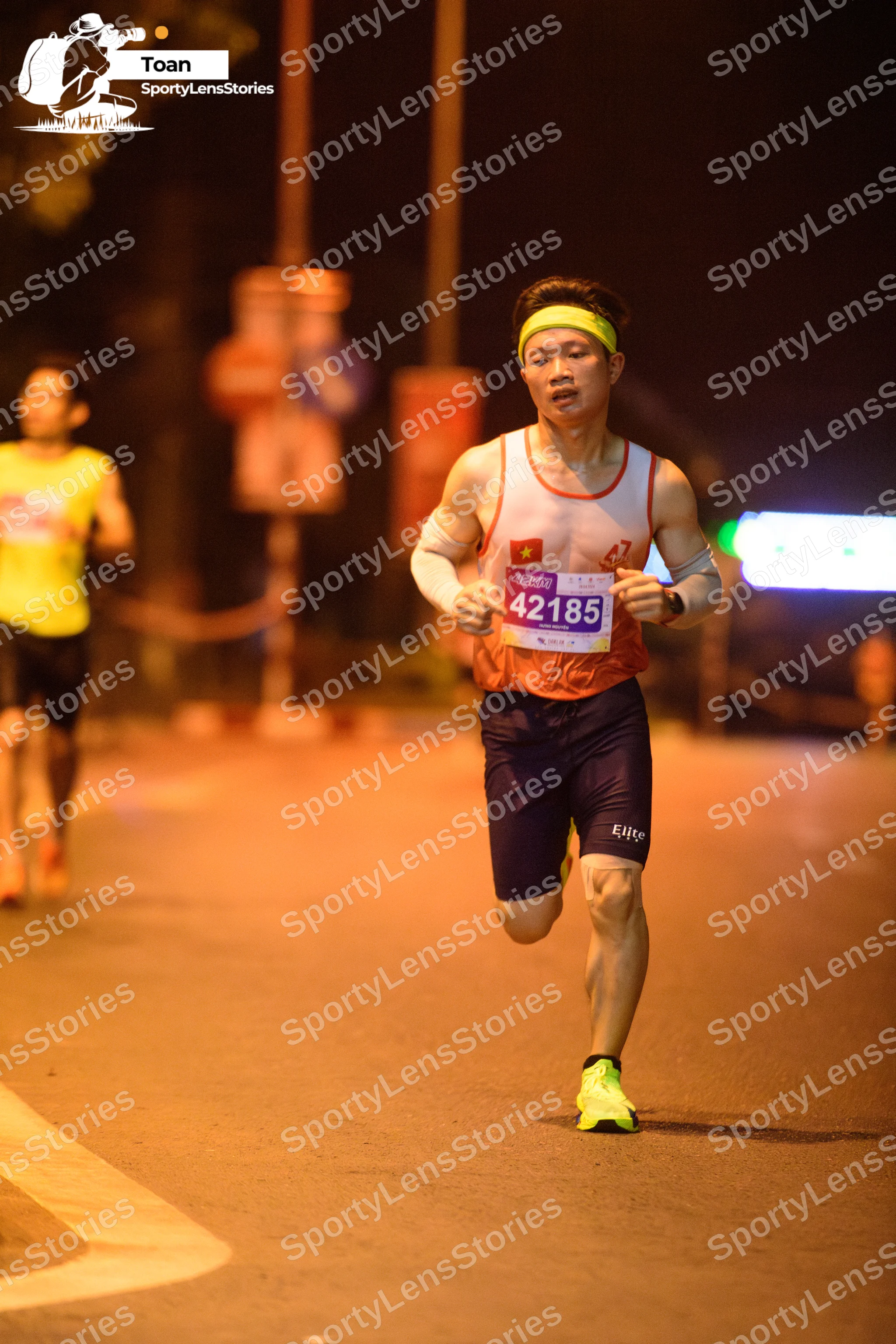 Marathon runner #42185: Runner 1: orange tank top, dark blue shorts, bright yellow shoes, yellow headban