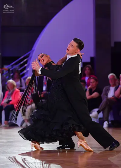 Dancesport competitor: Male dancer: black suit with black trousers and black dance shoes