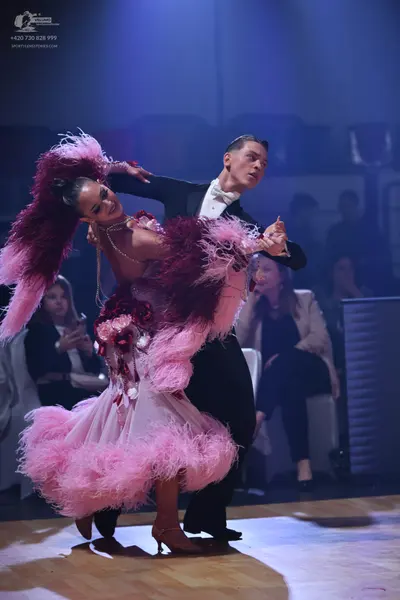 Dancesport competitor: Male dancer: black suit with white shirt and white bowtie