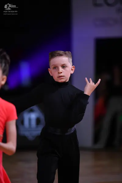 Dancesport competitor: Male dancer: black long-sleeved turtleneck top and black trousers with a satin w