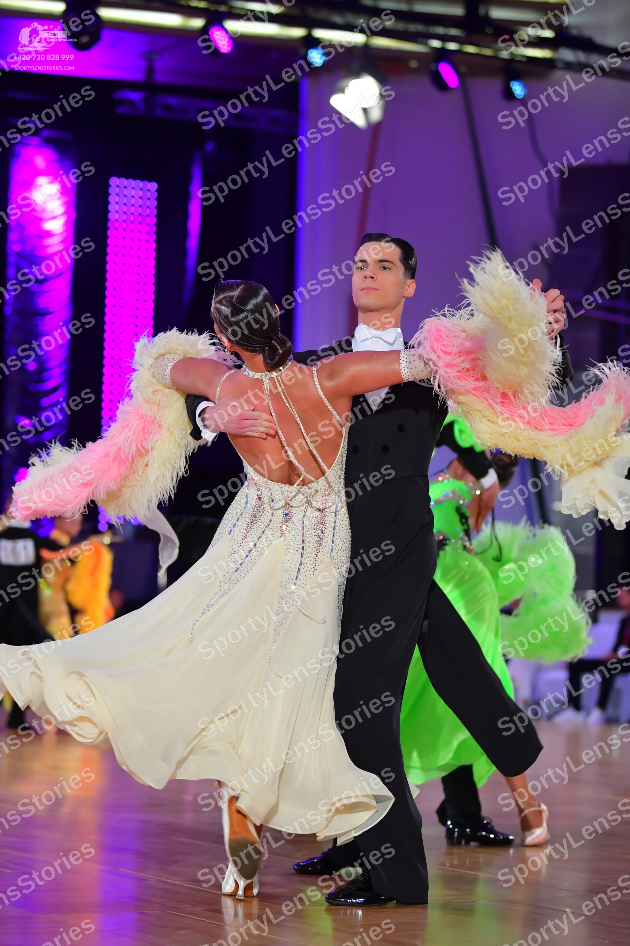 Dancesport competitor: Male dancer: black suit with a white shirt and white bow tie