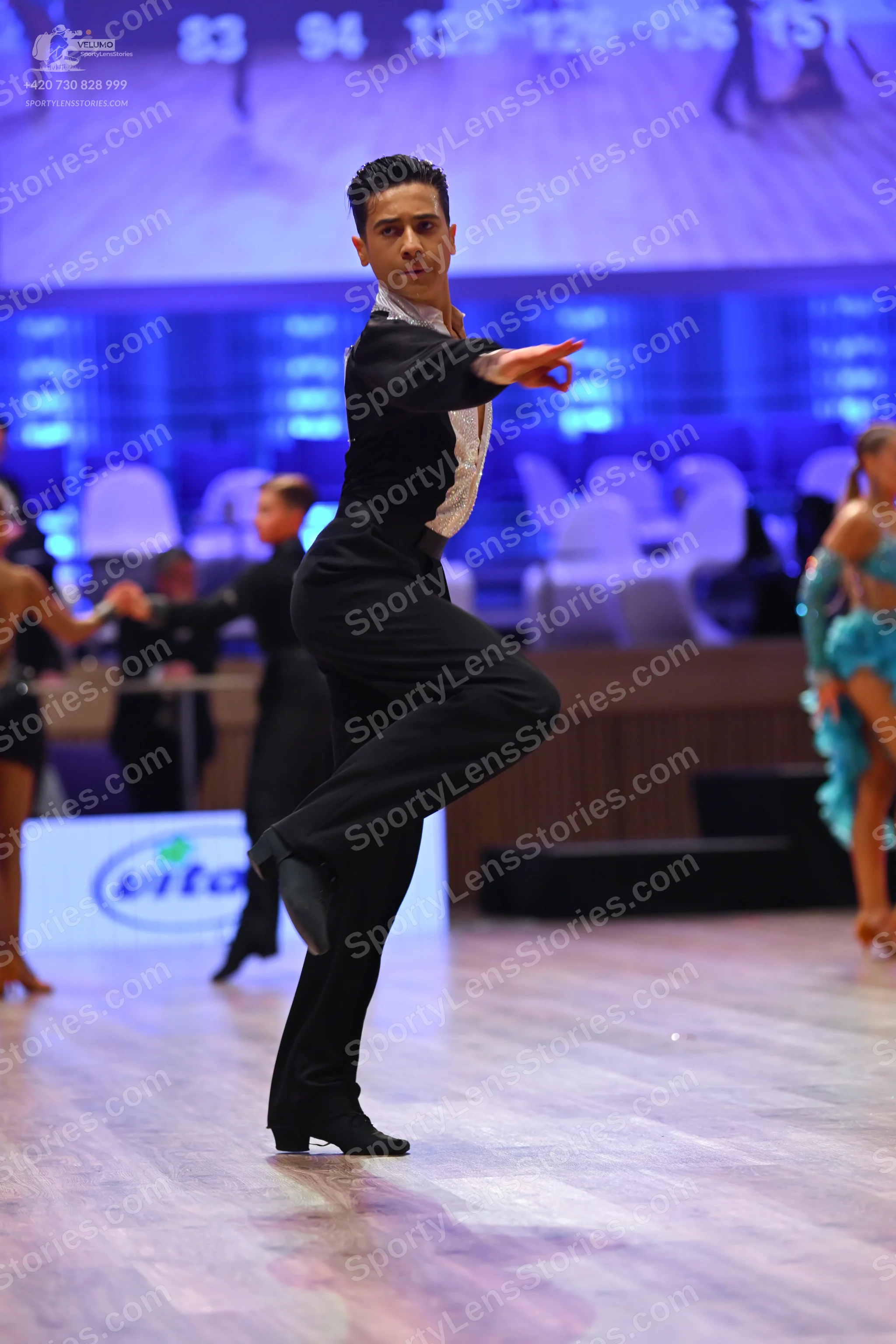 Dancesport competitor: Male dancer: black long-sleeved shirt with white front panel and black trousers