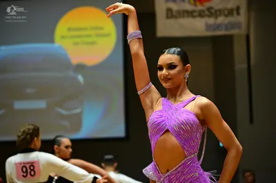 Dancesport competitor #98: Female dancer: purple Latin dress with sequins and cut-out details, matching seq