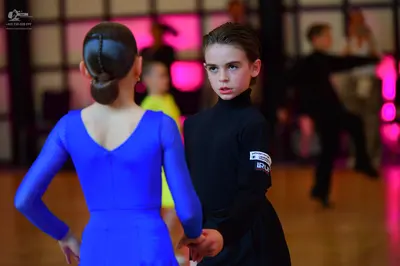 Dancesport competitor: Female dancer: blue long-sleeved dress, solid color, smooth fabric