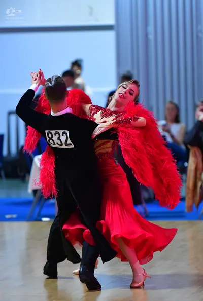 Dancesport competitor #832: Male dancer: black long-sleeved top with a white collar