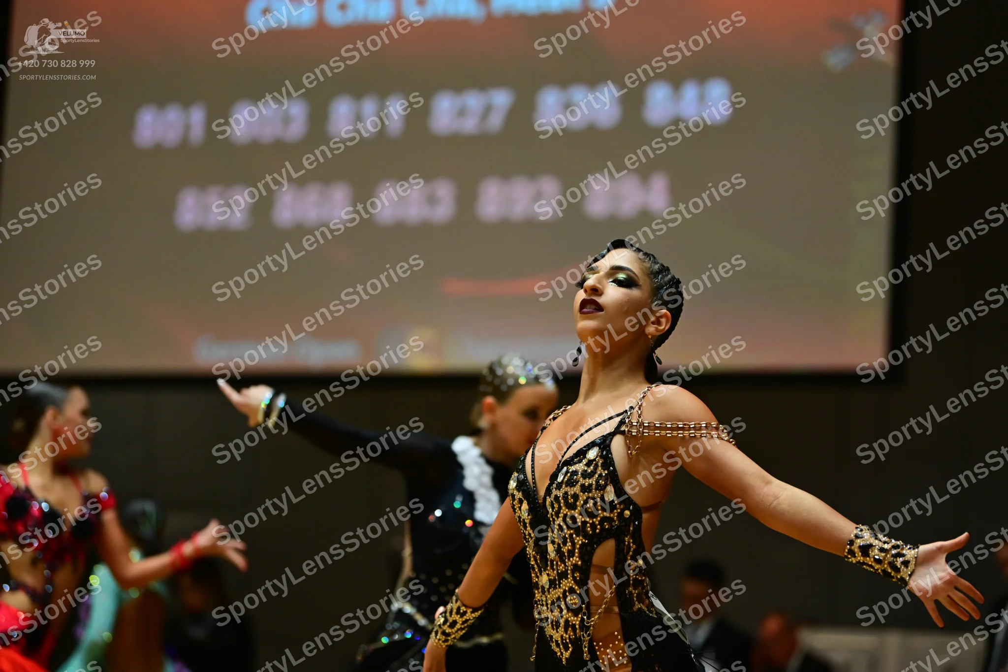 Dancesport competitor: Female dancer: red and black latin dress