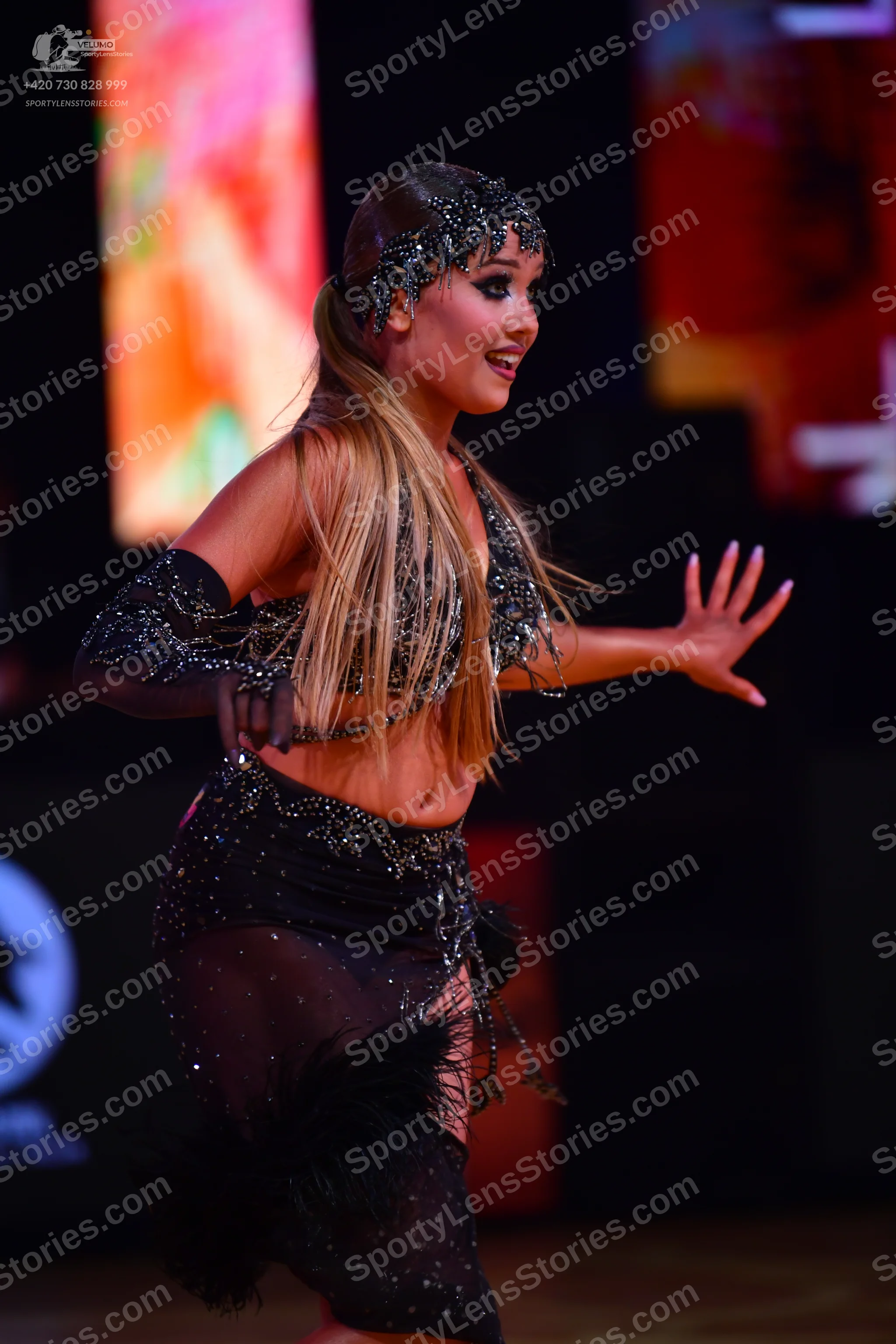 Dancesport competitor: Female dancer: black Latin dance costume embellished with sequins and crystals, 