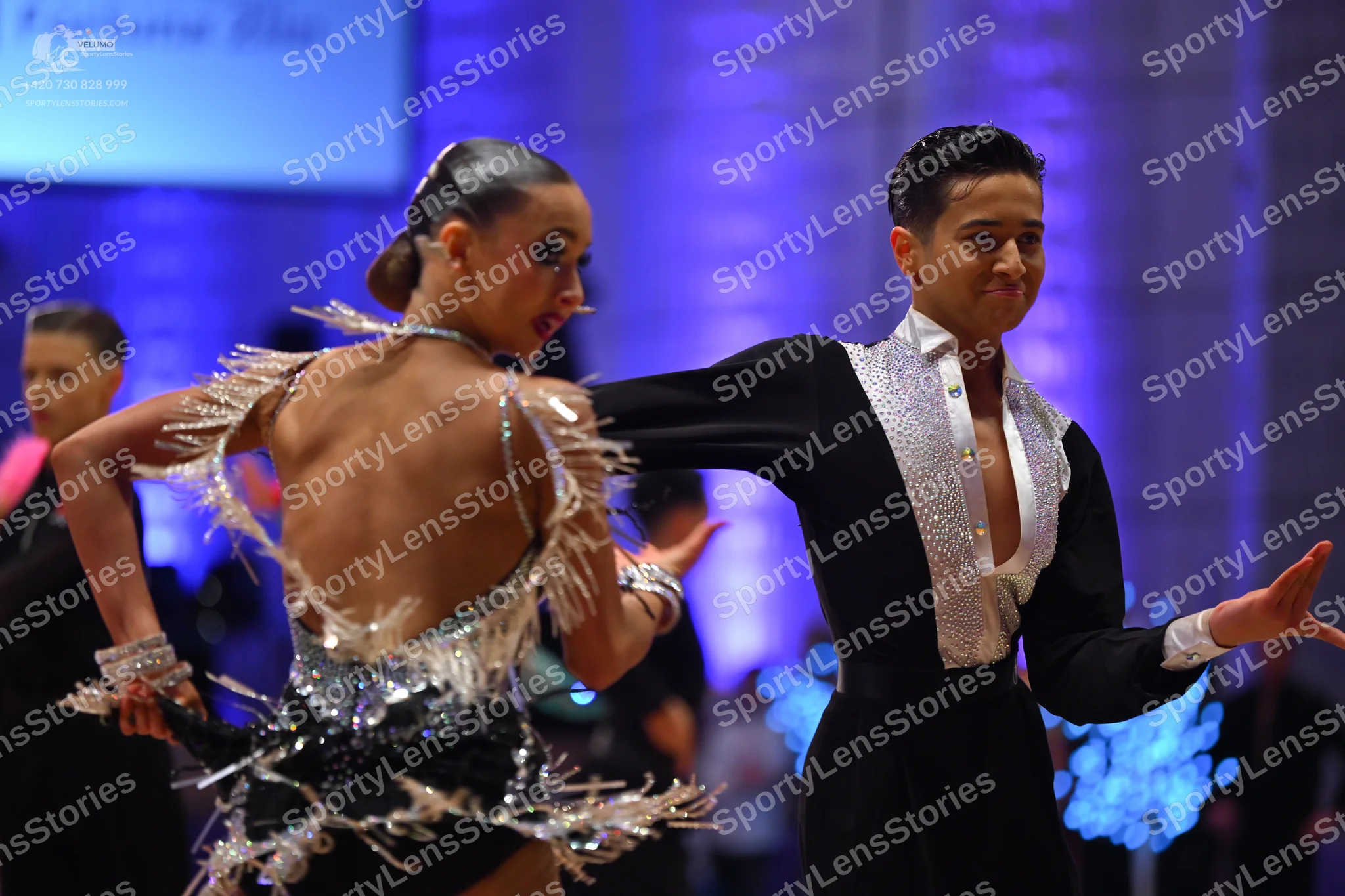 Dancesport competitor: Female dancer: black latin dress with silver sequins and fringe, and matching se