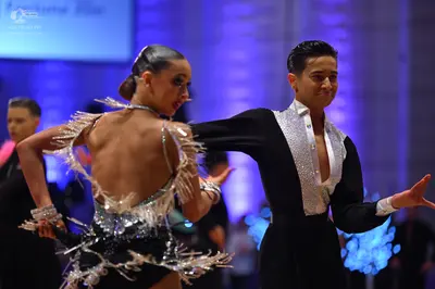 Dancesport competitor: Female dancer: black latin dress with silver sequins and fringe, and matching se
