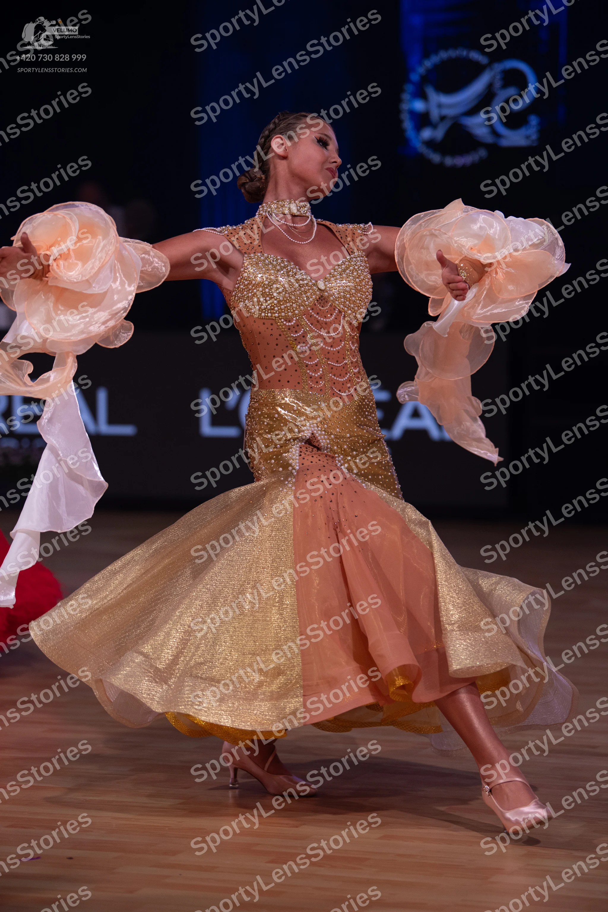 Dancesport competitor: Female dancer: champagne-colored ballroom dress with a sequined bodice and skirt