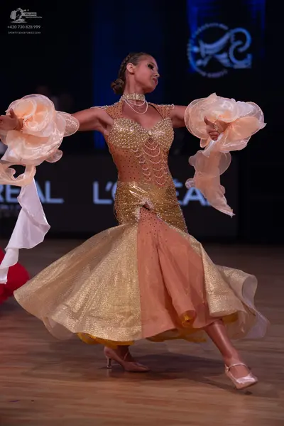Dancesport competitor: Female dancer: champagne-colored ballroom dress with a sequined bodice and skirt