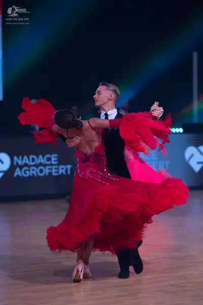 Dancesport competitor: Male dancer: black suit with a white shirt and black tie