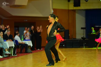 Dancesport competitor: Male dancer: black long-sleeved shirt with subtle sequins and black dance trouse