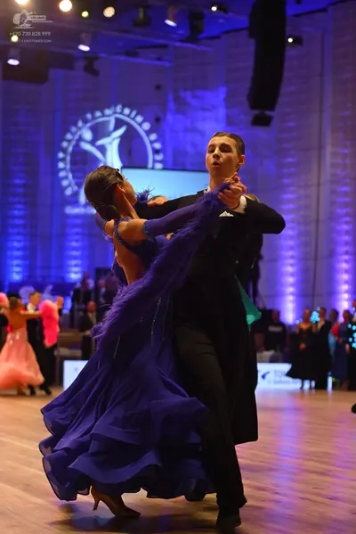 Dancesport competitor: Male dancer: black ballroom suit with a white shirt