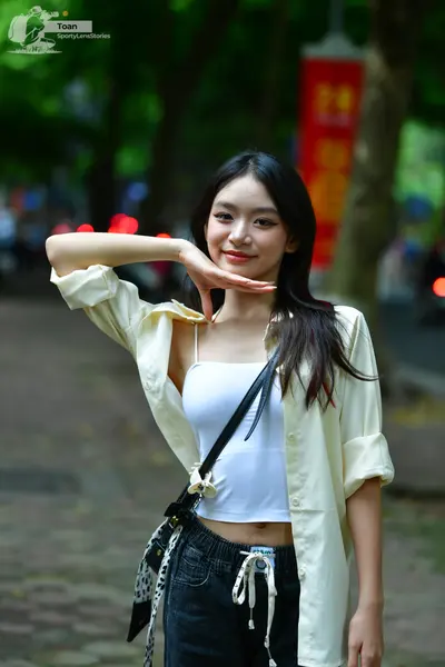 Dancesport competitor: Female dancer: white/cream-colored open button-down shirt, white tank top, and d