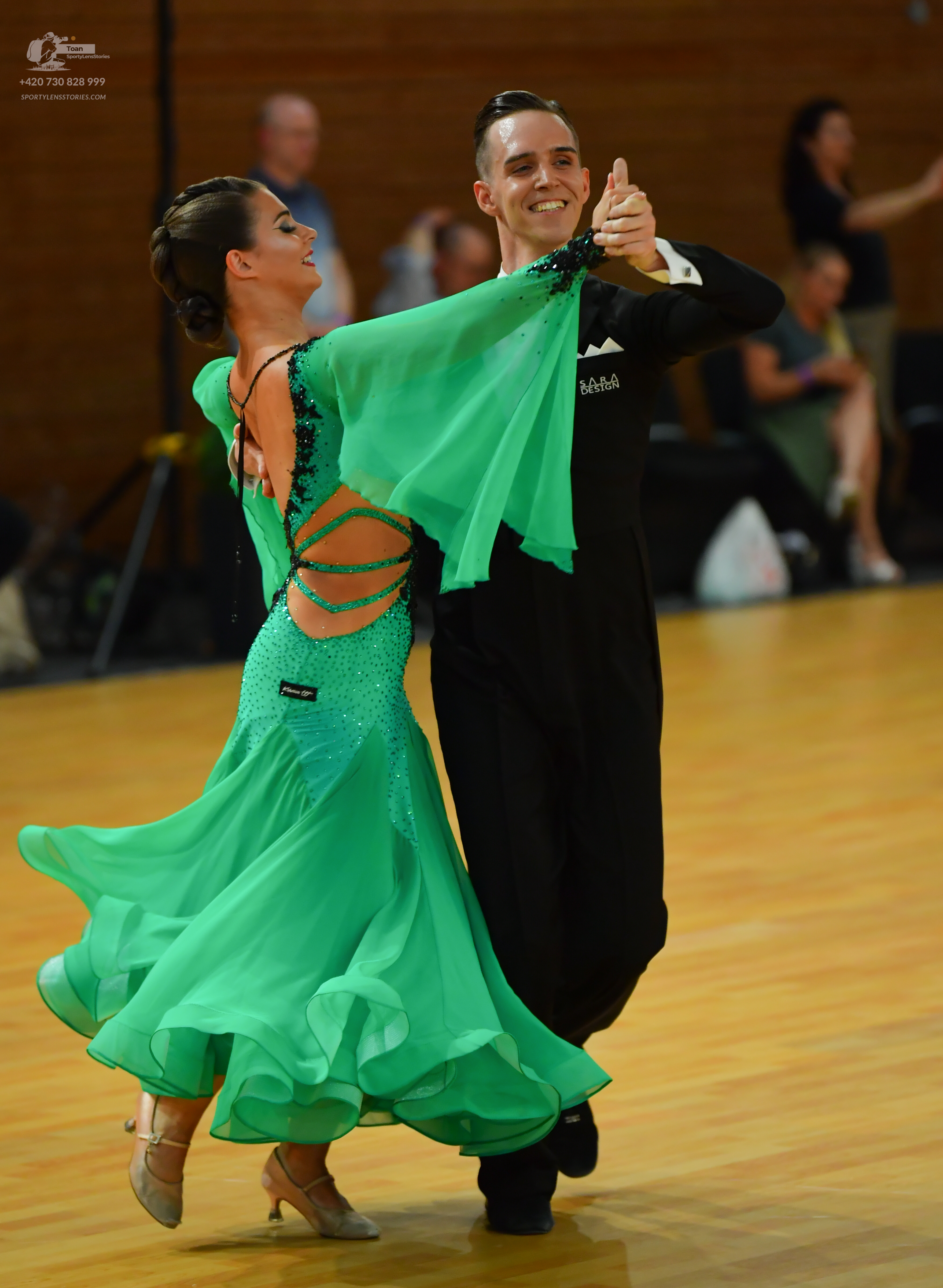 Dancesport competitor: Male:** Black tailsuit with a subtle sheen or possibly a satin finish