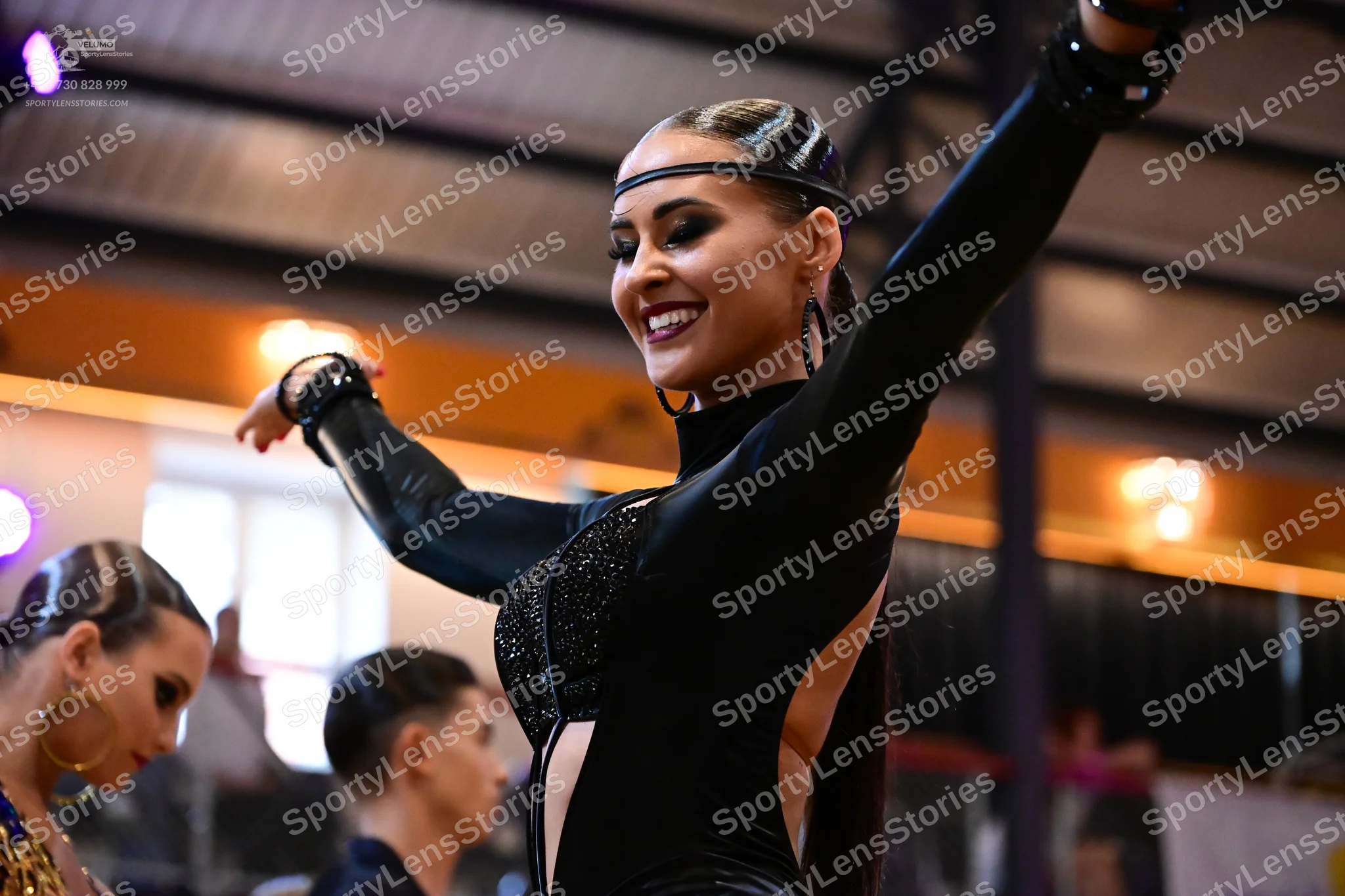 Dancesport competitor: Main female dancer: black long-sleeved latin dance costume with a sequined bodic