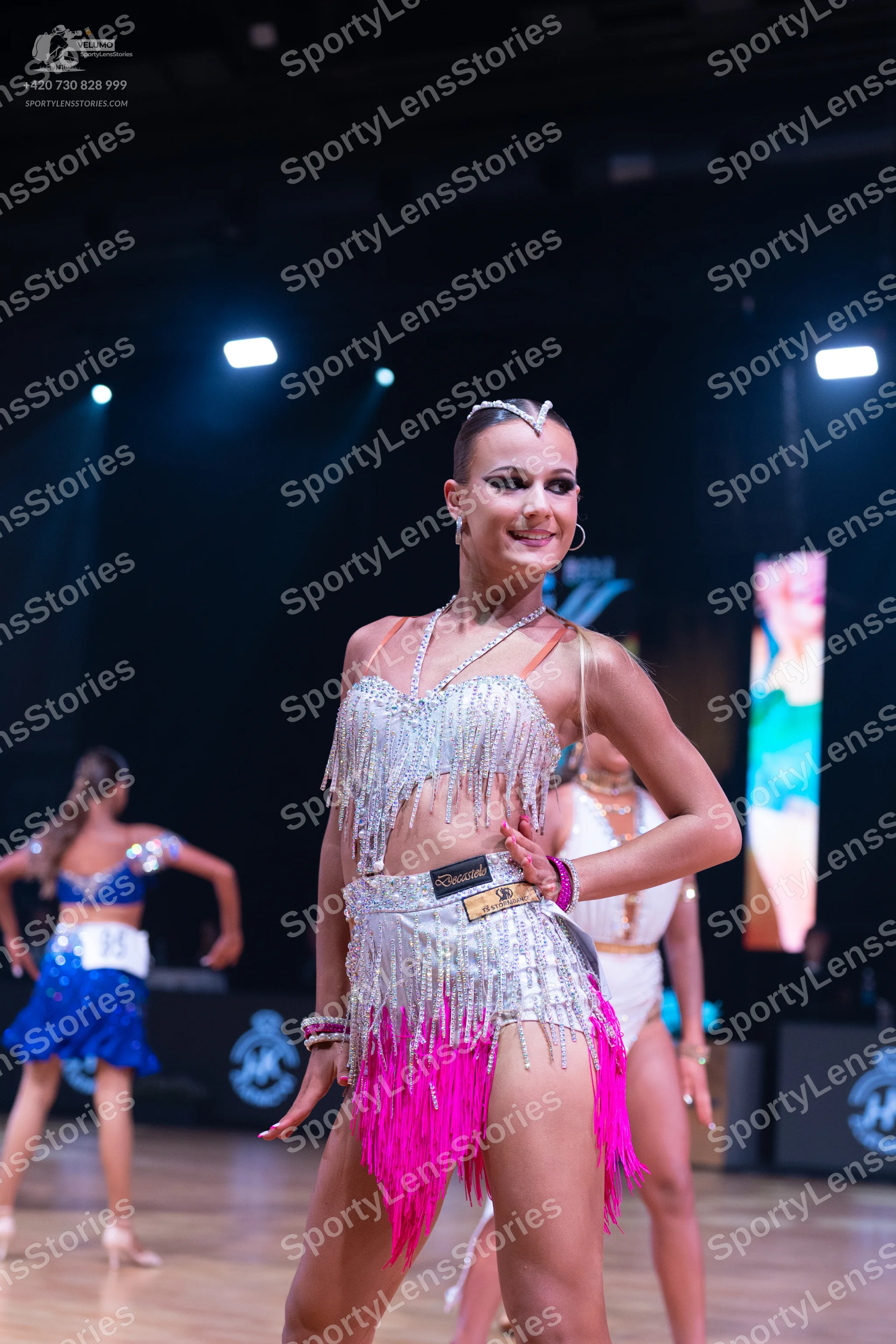 Dancesport competitor: Female dancer 1: blue latin dress with a sequined top and a blue skirt