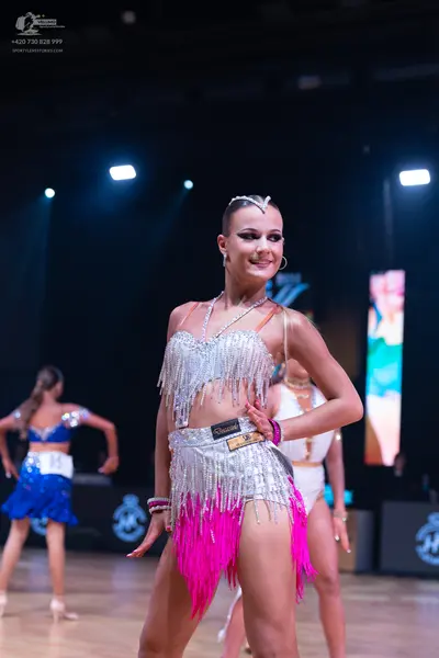 Dancesport competitor: Female dancer 1: blue latin dress with a sequined top and a blue skirt