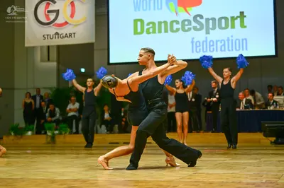 Dancesport competitor: Male dancer: black long-sleeve shirt and black trousers