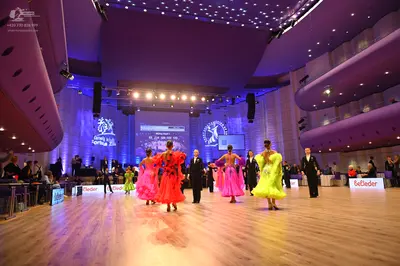 Dancesport competitor: Female dancer: bright pink/red latin dress, sleeveless