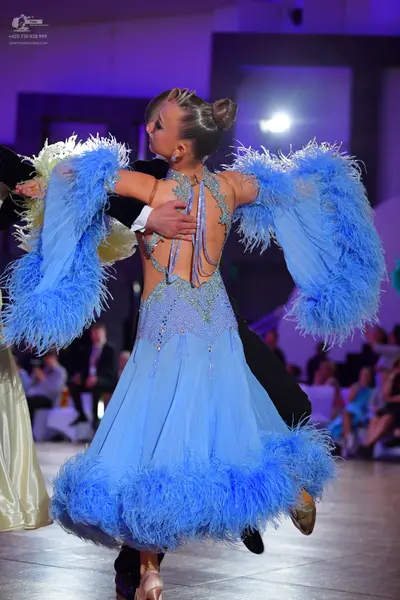 Dancesport competitor: Female dancer: light blue ballgown with silver sequin/beadwork on the bodice and