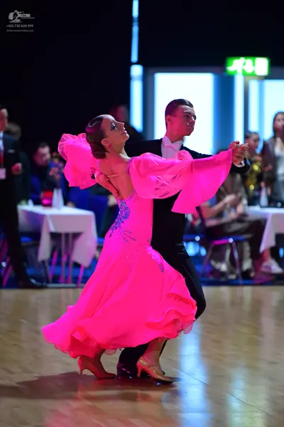 Dancesport competitor: Male dancer: black suit with a white shirt and white bow tie