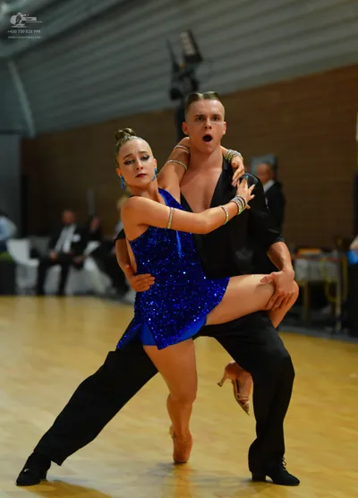 Dancesport competitor: Male:** Black, fitted suit with a tailored jacket and pants