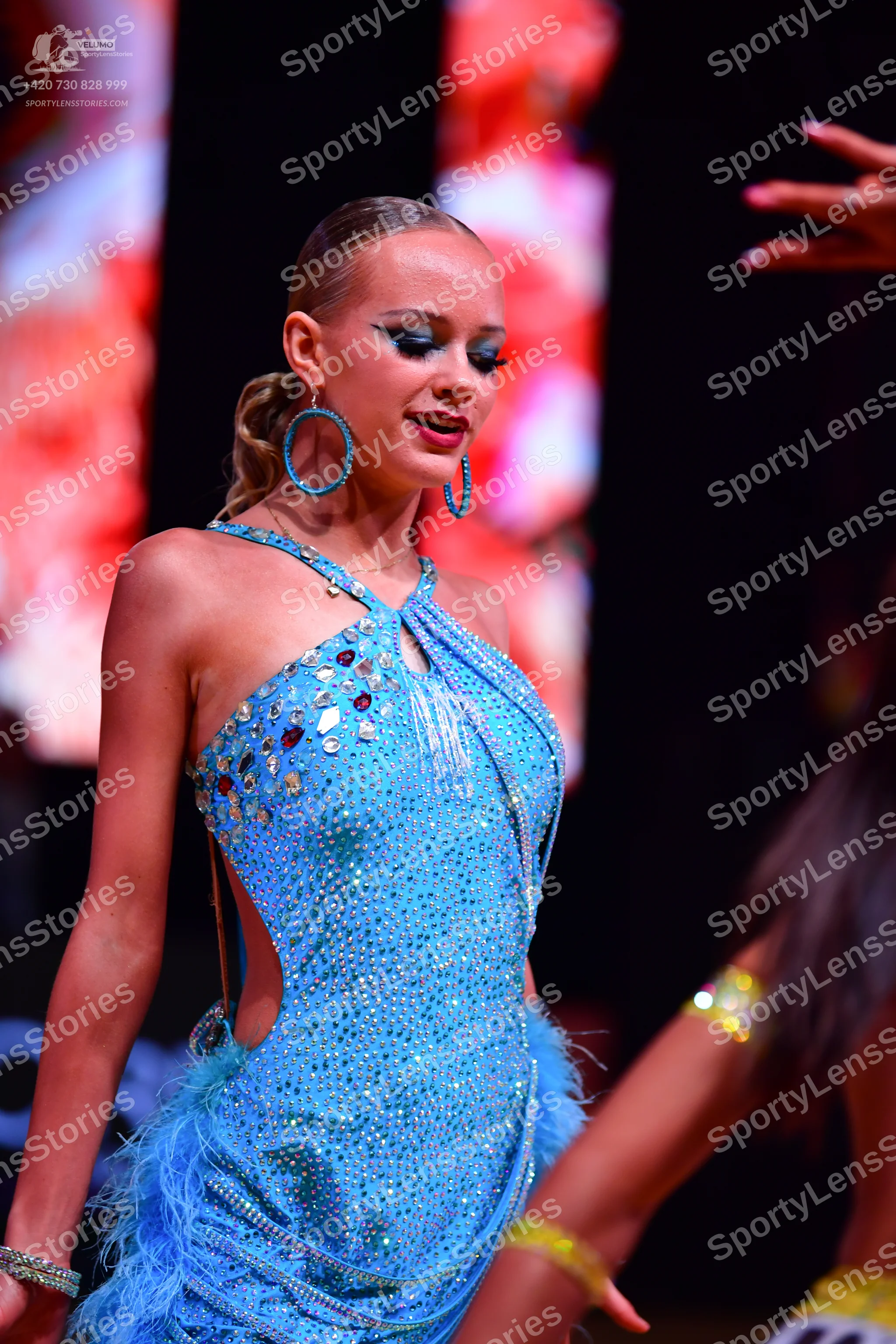 Dancesport competitor: Female dancer: light blue sequin latin dress with a halter neck, side cutouts, a
