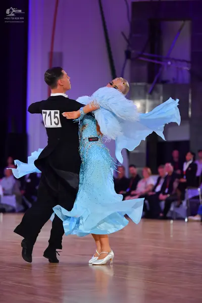 Dancesport competitor #715: Male dancer: black long-sleeved shirt and black trousers