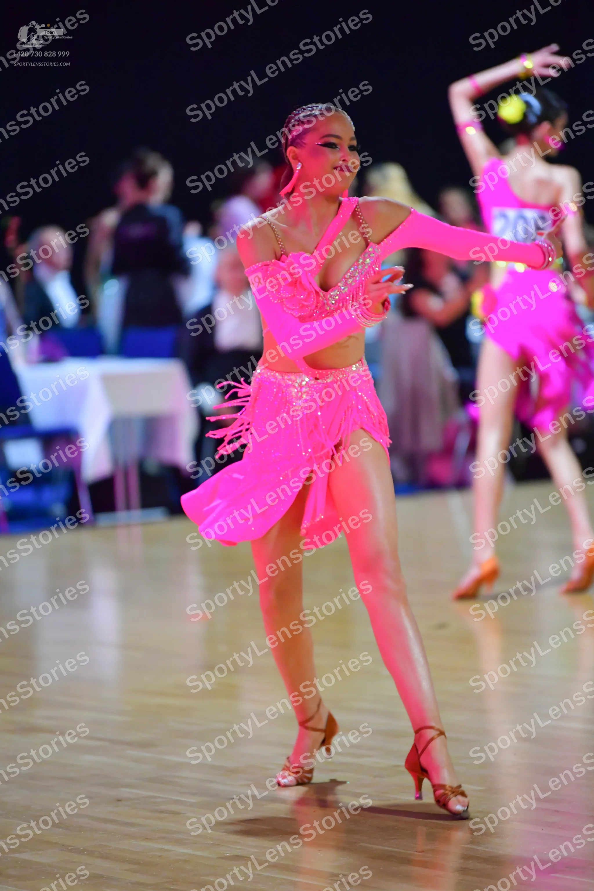 Dancesport competitor #208: Female dancer (foreground): bright pink Latin dance dress with sequin embellishm