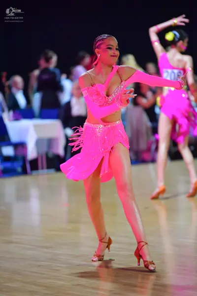 Dancesport competitor #208: Female dancer (foreground): bright pink Latin dance dress with sequin embellishm
