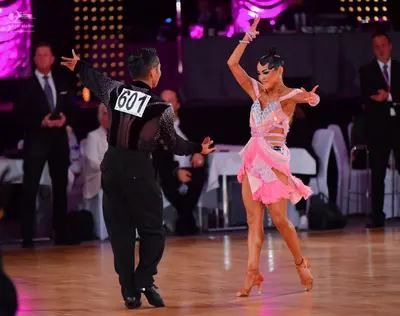 Dancesport competitor #601: Male dancer: black long-sleeved top with shimmering/sequin details and black tro