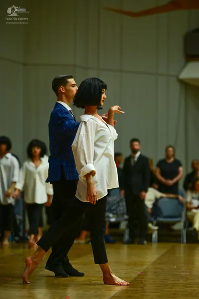 Dancesport competitor: Male dancer: blue patterned blazer and black trousers