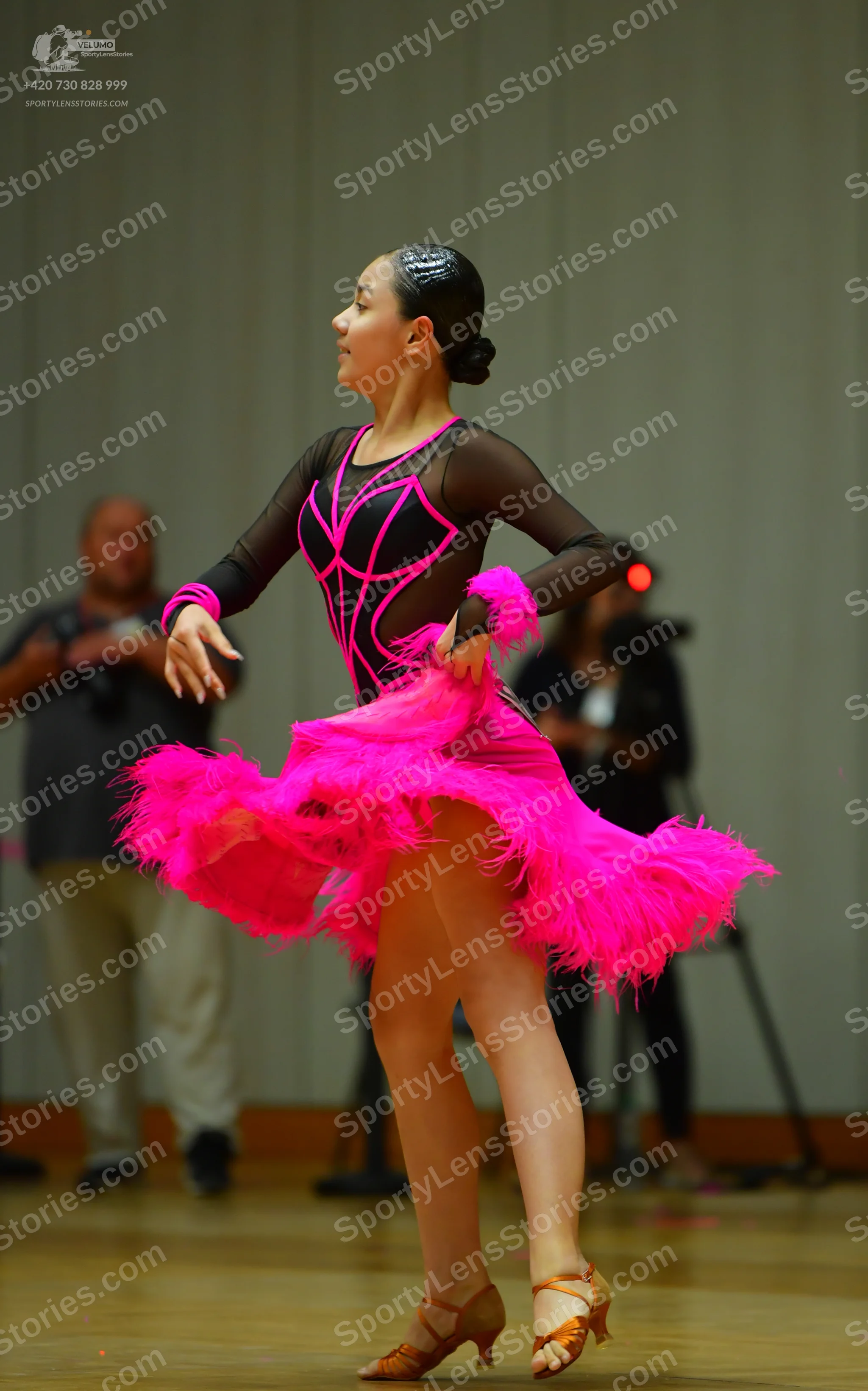 Dancesport competitor: Female dancer: black and bright pink latin dance dress featuring a sheer black m