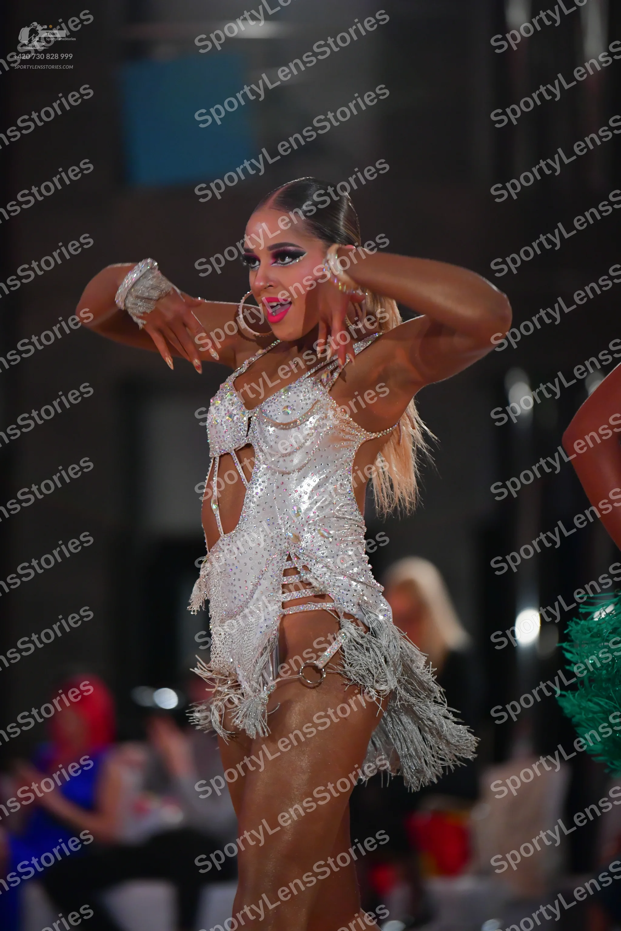 Dancesport competitor: Female dancer: silver/white Latin dance dress with heavy sequin/crystal embellis