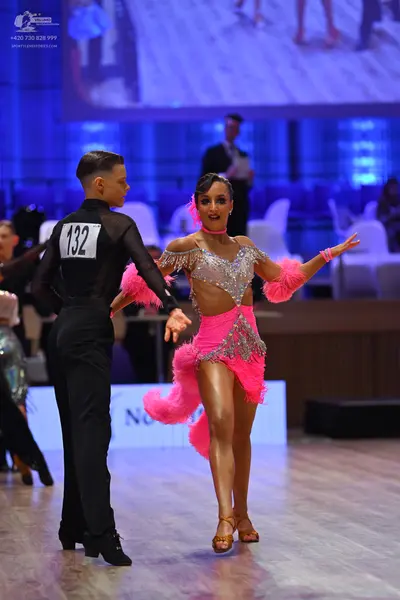 Dancesport competitor: Male dancer: black long-sleeved mesh shirt and black trousers