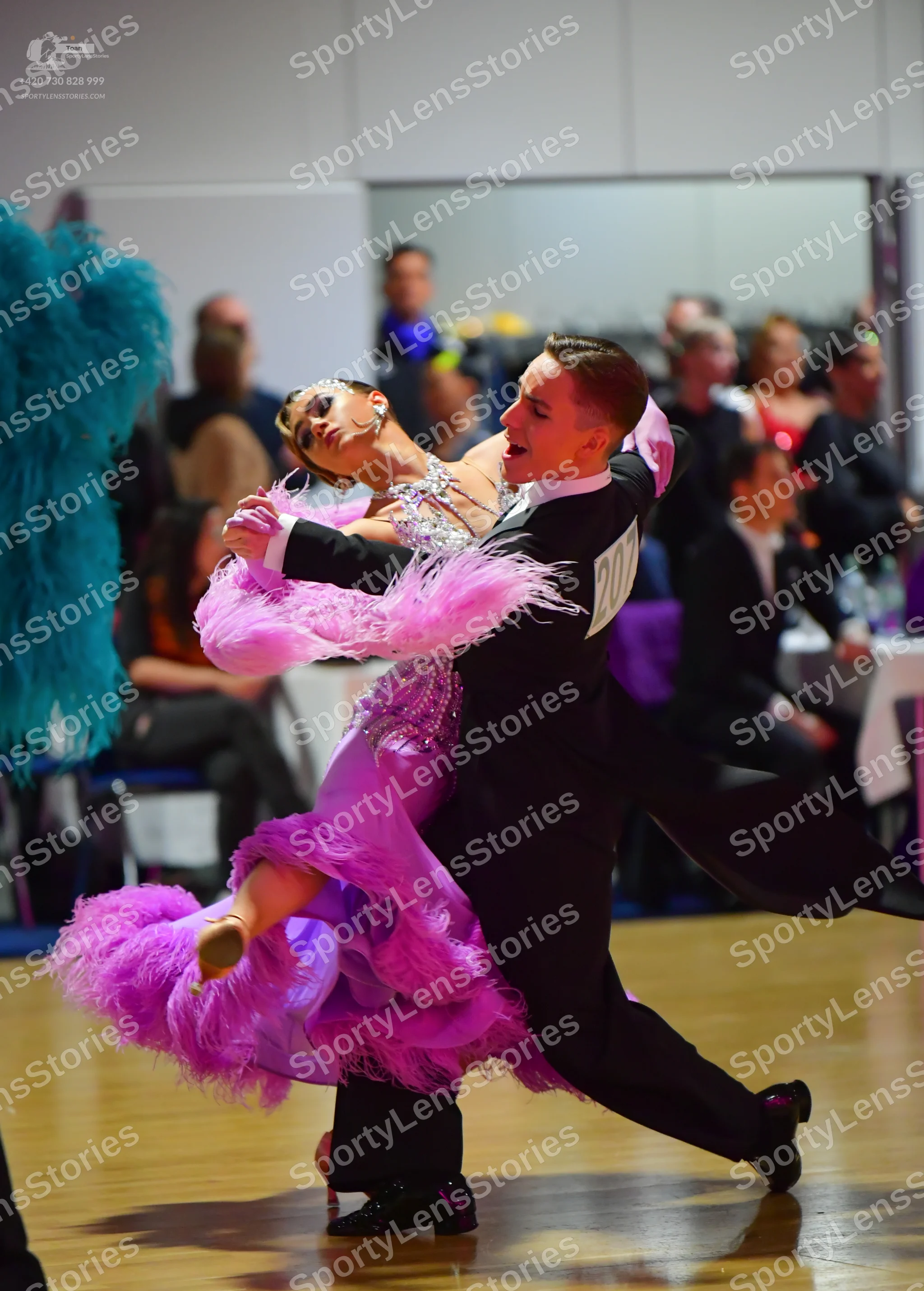 Dancesport competitor: Female dancer: bright pink Latin dance dress with a sequined bodice and large, v