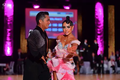 Dancesport competitor: Male dancer: black long-sleeve shirt with silver sequins on the shoulder and sle