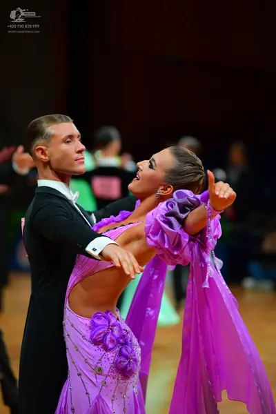 Dancesport competitor: Male dancer: black suit with a white shirt and white bow tie