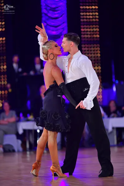 Dancesport competitor: Male dancer: white long-sleeve shirt and black trousers