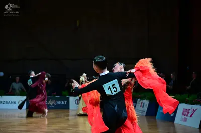 Dancesport competitor #15: Male dancer in foreground: black long-sleeve shirt and black trousers