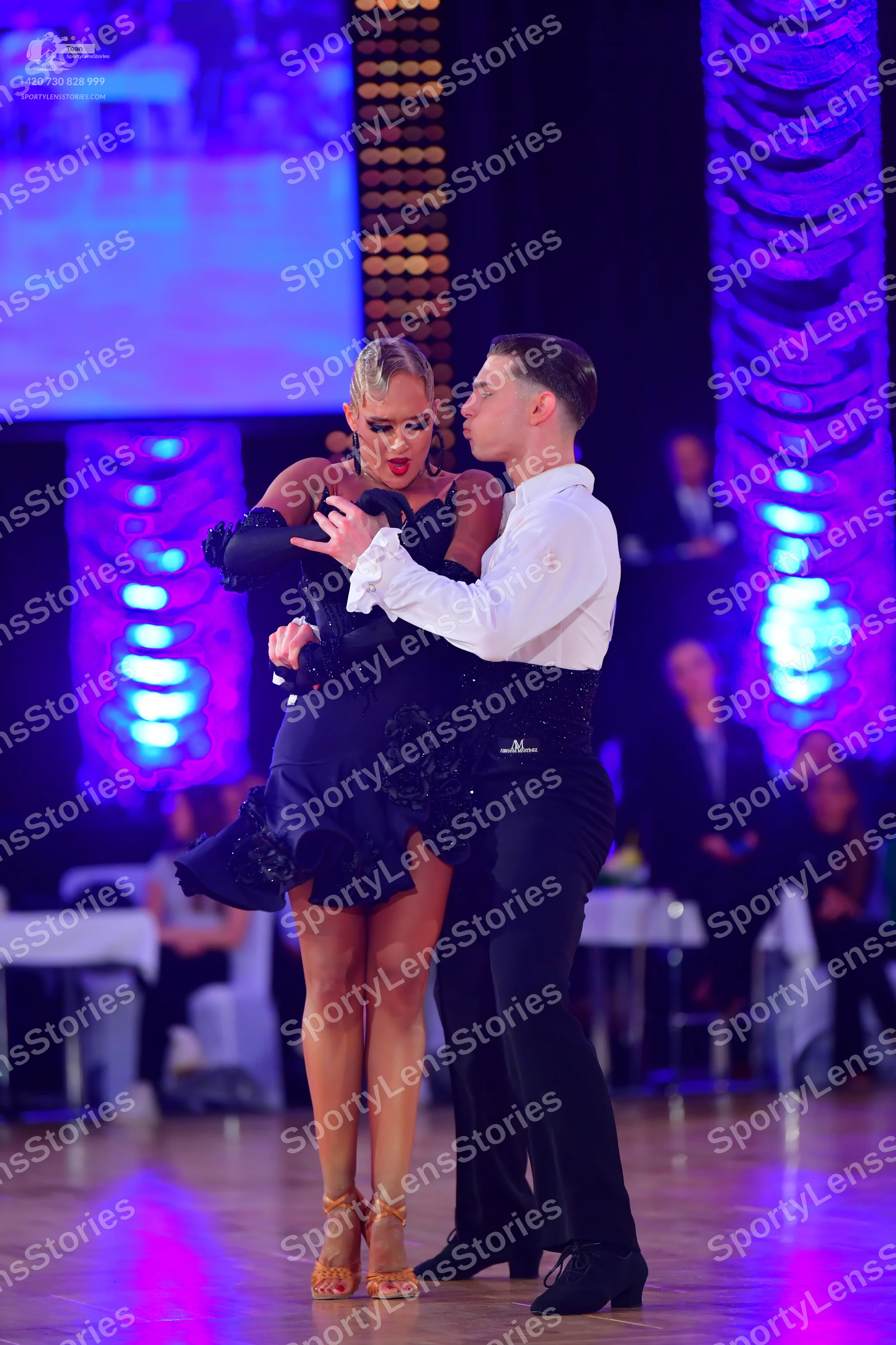 Dancesport competitor: Male dancer: white long-sleeved shirt, black trousers, and a black cummerbund