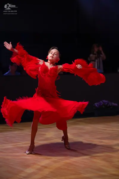 Dancesport competitor: Female dancer: red latin dress with fringe